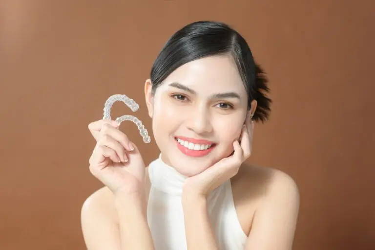young woman beautiful teeth holding invisalign clear aligners healthy dental concept - How Long Does Invisalign Take in Leominster and Gardner, MA